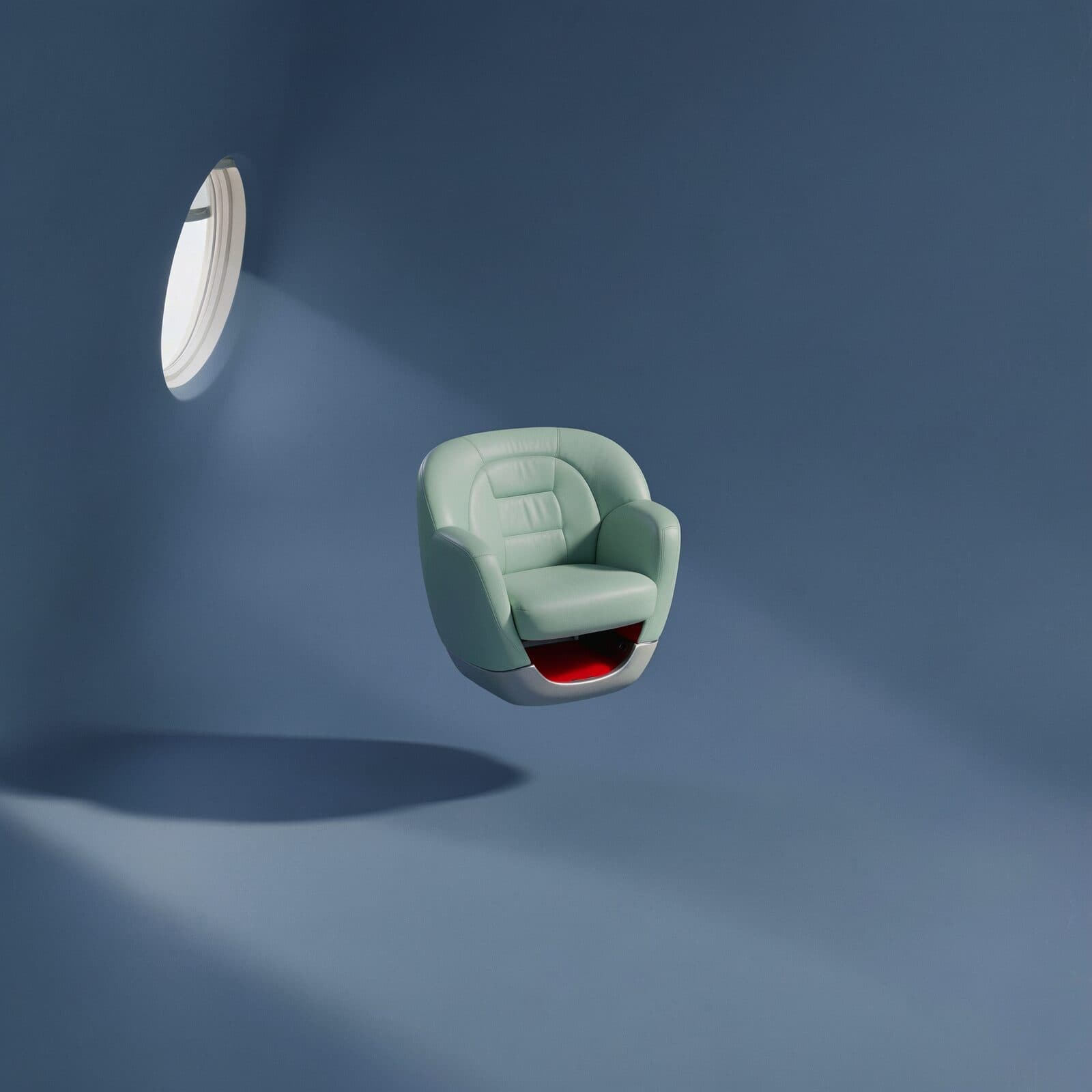 A mint-green leather armchair on a silver base hangs in the middle of a plain blue-grey room, lit by a single oval window high on the left, casting a long soft shadow. Red upholstery shows in the cut-away underside.