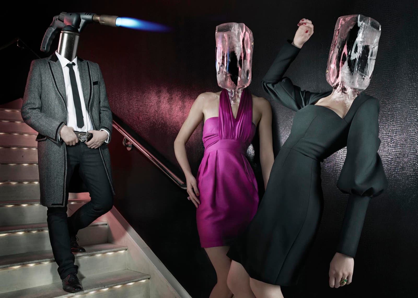 A blowtorch-headed man and two women with ice-block heads on a nightclub staircase. Dimitri Daniloff